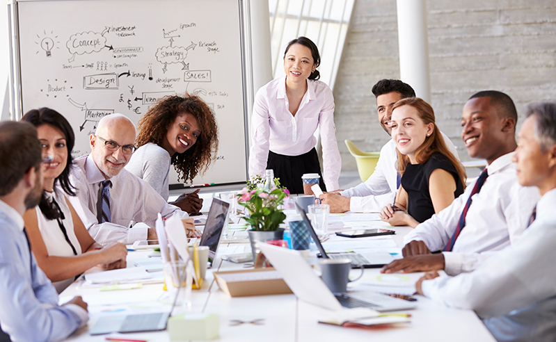 Business colleagues discussing in an office with ideas on a white board